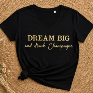 Tee-shirt noir col V - Slogan "Dream big and drink champagne" en doré pailleté. Création La Strasseuse